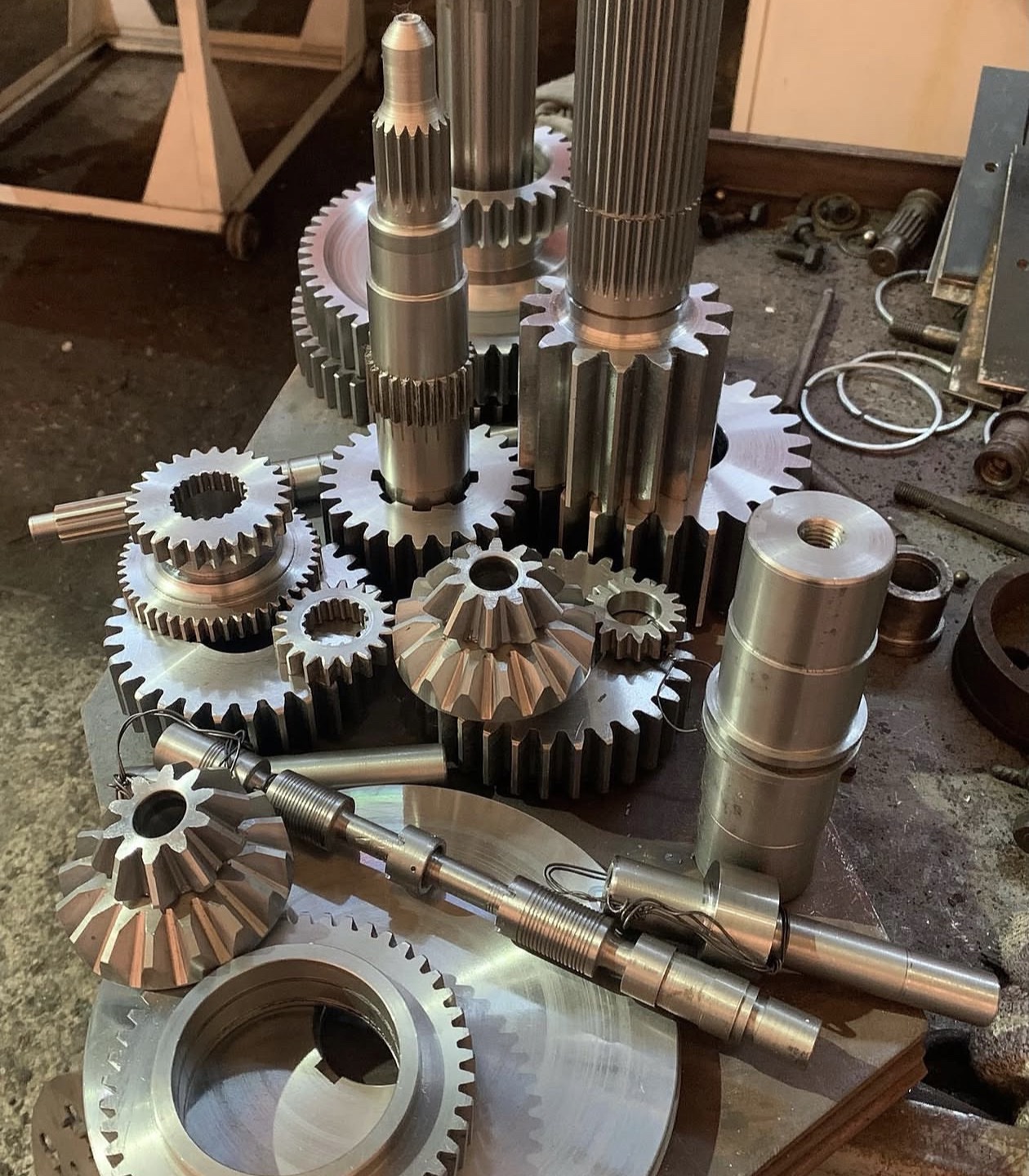 Machined shafts and gear components on a workbench