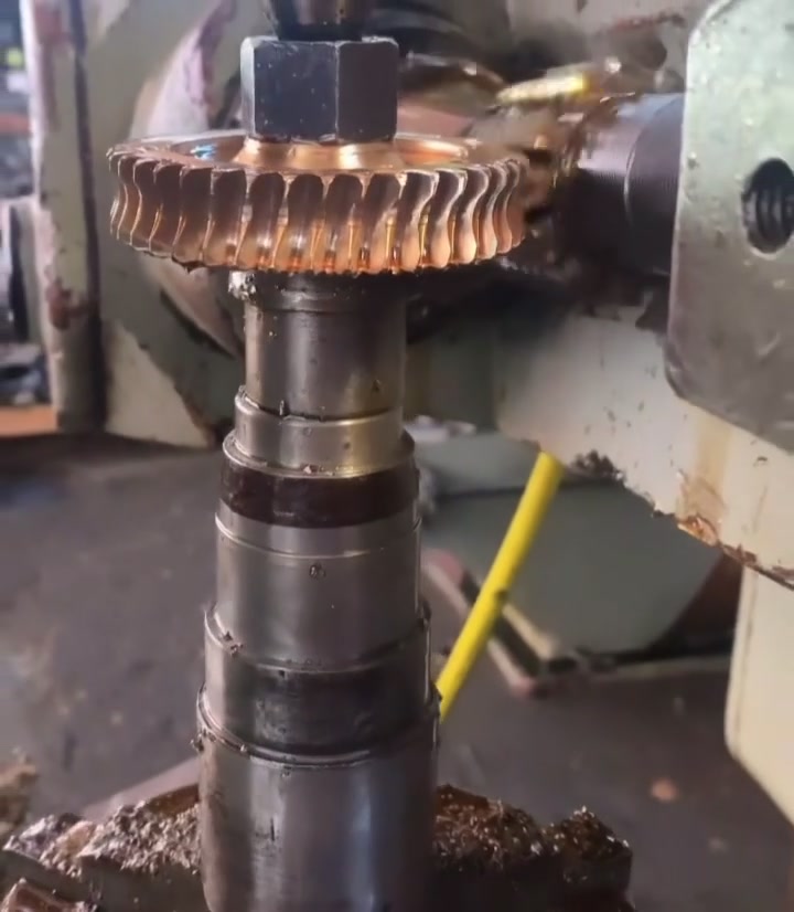 Close-up of a bronze worm gear being precision-cut in the LA Trucks and Tractors shop