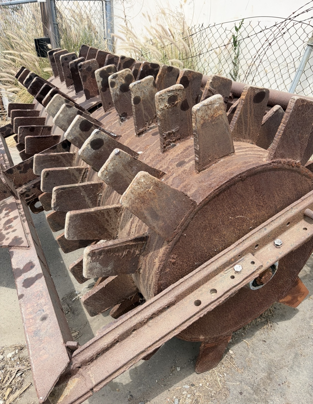 Heavily worn and rusted rotary drum attachment before rebuilding